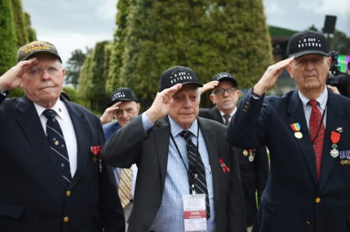 US veterans Jack Gutman (C), Georges Ciampa (2R) and James Forlking (R), landed on "Omaha Beach" on June 6, 1944