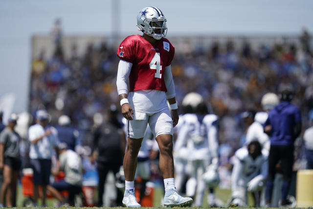 Dallas Cowboys quarterback Dak Prescott (4) alongside Tyron Smith (77)  during a Thanksgiving day NFL football game against the Las Vegas Raiders,  Thursday, Nov. 25, 2021, in Arlington, Texas. (AP Photo/Matt Patterson