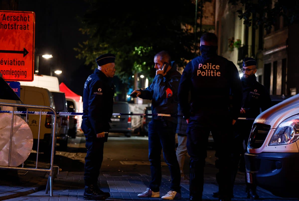 Police officers stand guard near the scene of a stabbing attack (AFP via Getty Images)