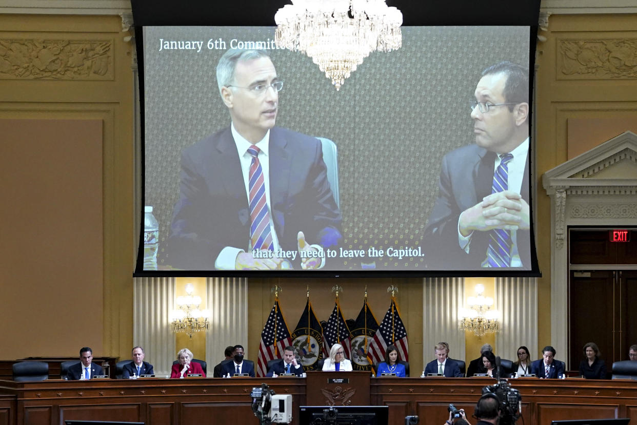 A video showing onscreen above members of the House select committee shows Pat Cipollone with caption reading: that they need to leave the Capitol.