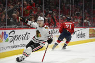 Chicago Blackhawks left wing Dominik Kubalik (8) celebrates his goal as Washington Capitals right wing Garnet Hathaway (21) skates away during the second period of an NHL hockey game Thursday, Dec. 2, 2021, in Washington. (AP Photo/Nick Wass)