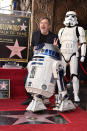 <p>The <em>Star Wars</em> icon was (naturally!) flanked by R2D2 and a storm trooper while being honored with a star on the Hollywood Walk of Fame on Thursday in Hollywood. (Photo: Alberto E. Rodriguez/Getty Images for Disney) </p>