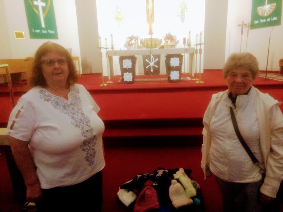 Sue Barry, left, and Sandy Falank look over some of the donations of winter clothing parishioners at St. Paul’s Church collected for those in need. The church has been giving away winter clothing to those in need since the 1990's.