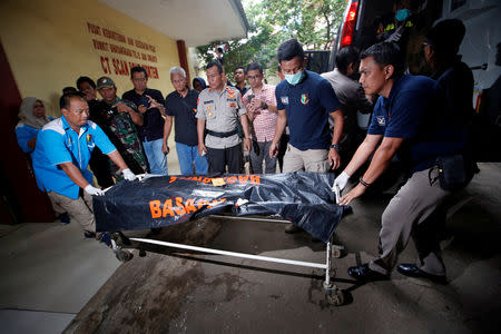 Officials carry a body bag off an ambulance at Bhayangkara R. Said Sukanto hospital in Jakarta, Indonesia, October 30, 2018. REUTERS/Willy Kurniawan