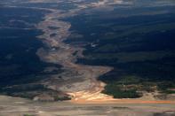 FILE - This Sept. 13, 2013 aerial file photo shows a river polluted by waste from informal mining in Peru's Madre de Dios region. The clock has run out for an estimated 40,000 illegal gold miners who had until Saturday to legalize their status in a region of southeastern Peru where fortune-seekers have ravaged rainforests and contaminated rivers. (AP Photo/Rodrigo Abd,File)