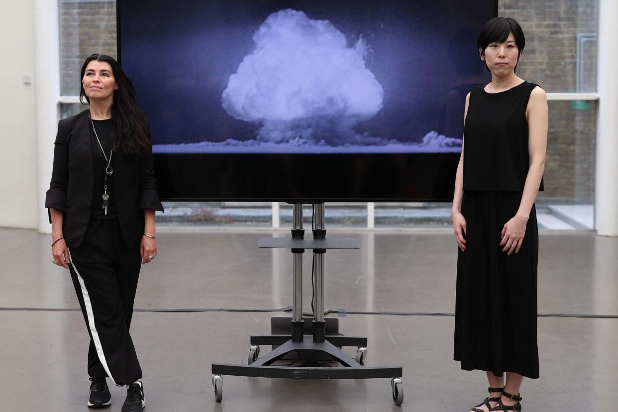 Artists Es Devlin (left) and Machiko Weston pose next to their digital art collaboration 'The End of the World': PA