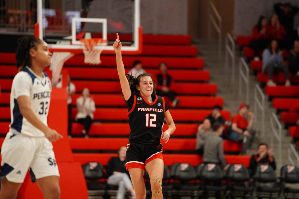 Kate Peek, a freshman on the Fairfield women's basketball team, raises a finger in celebration after a victory during the 2022-23 season.