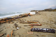 A view of parts of the wreckage of a capsized boat that was washed ashore at a beach near Cutro, southern Italy, Monday, Feb. 27, 2023. Rescue crews searched by sea and air Monday for the dozens of people believed still missing from a shipwreck off Italy’s southern coast that drove home once again the desperate and dangerous crossings of migrants seeking to reach Europe. (AP Photo/Valeria Ferraro)