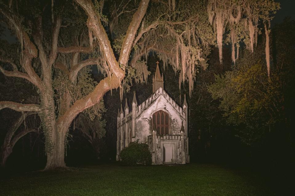 A small, old church in a swap at night