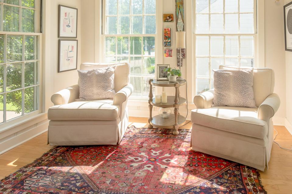 The sunroom is a quiet space to sit and relax with a book.