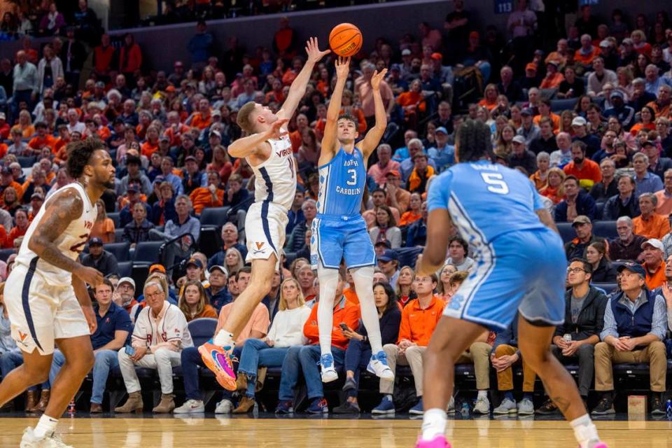 North Carolina’s Cormac Ryan (3) puts up a three point shot over Virginia’s Isaac McKneely (11) in the second half on Saturday, February 24, 2024 at John Paul Jones Arena in Charlottesville, Va.