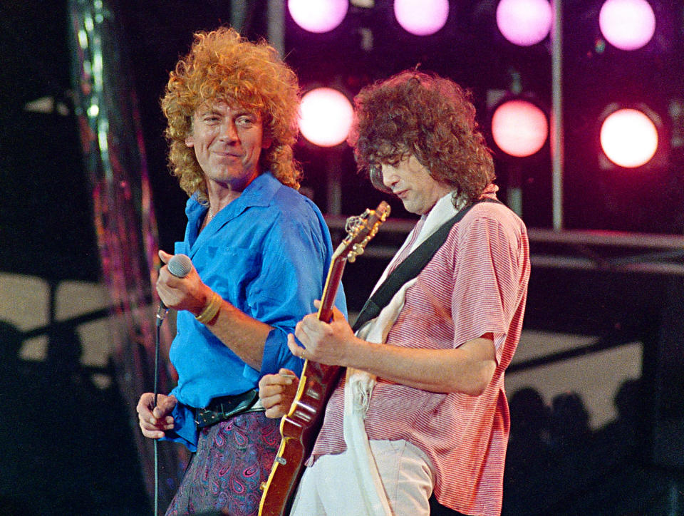 FILE - In this July 13, 1985 file photo, Led Zeppelin bandmates, singer Robert Plant, left, and guitarist Jimmy Page, reunite to perform for the Live Aid famine relief concert at JFK Stadium in Philadelphia. From left are John Bonham, Robert Plant, Denny and Jimmy Page. A federal appeals court on Monday, March 9, 2020, restored a jury verdict that found Led Zeppelin did not steal “Stairway to Heaven." (AP Photo/Amy Sancetta, File)