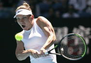 Romania's Simona Halep makes a backhand return to Kazakhstan's Yulia Putintseva during their third round singles match at the Australian Open tennis championship in Melbourne, Australia, Saturday, Jan. 25, 2020. (AP Photo/Dita Alangkara)