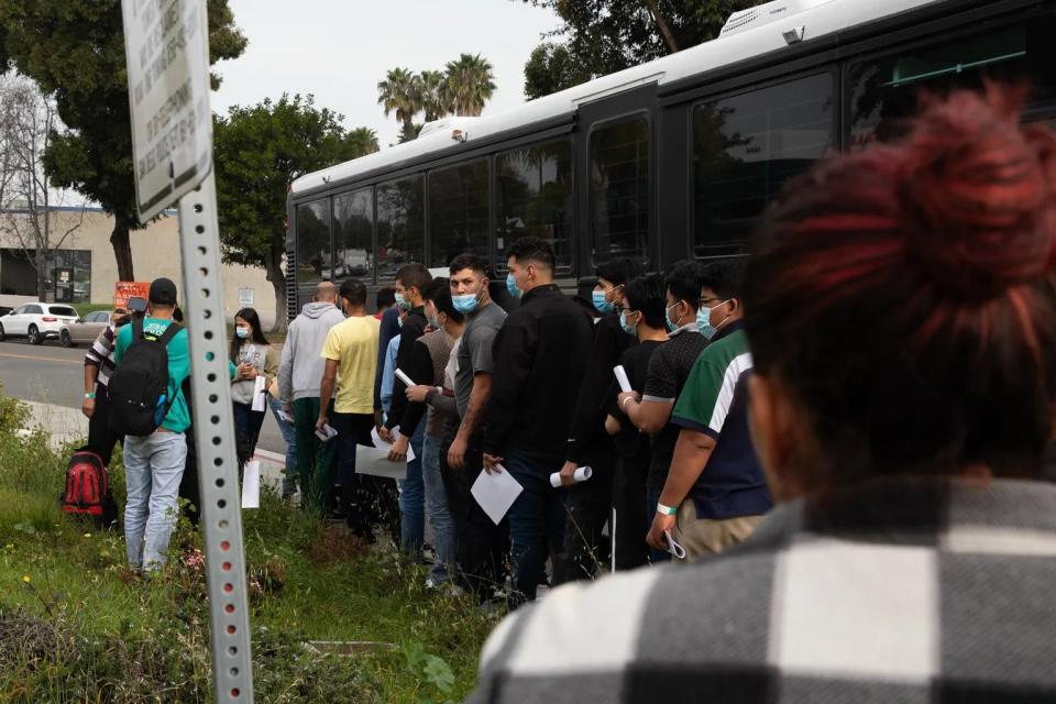 Migrants arrive at the Iris Avenue Transit Center after being dropped off by Border Patrol agents in San Diego on Feb. 25, 2024.