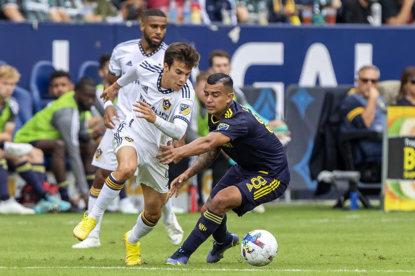 LA Galaxy midfielder Riqui Puig controls the ball with Nashville SC midfielder Randall Leal.