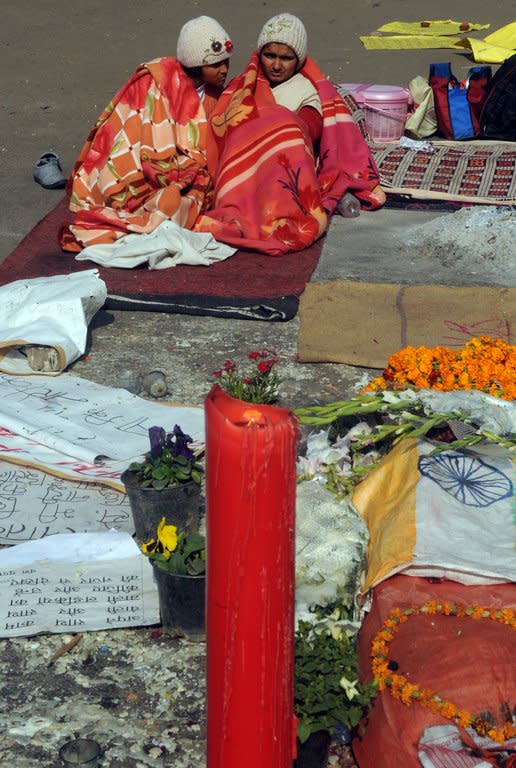 Indian activists keep warm with blankets during a protest in New Delhi on January 8, 2013, against the gang rape and murder of a student. Two of the five men accused of gang-raping and murdering a 23-year-old woman in a moving bus in New Delhi last month will plead not guilty to all charges, a lawyer said Tuesday