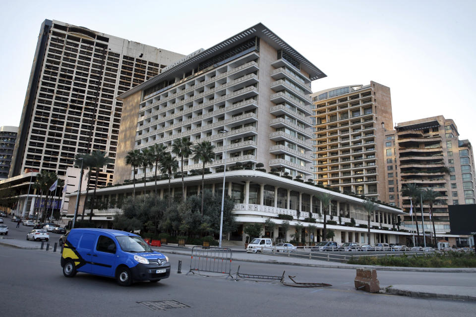 This Wednesday, Dec. 18, 2019 photo, cars passing in front of the Phoenicia Hotel, in Beirut, Lebanon. Lebanon's unprecedented economic crisis and two months of mass protests have taken a huge toll on hotel and restaurant industries, with massive losses reported by various businesses. (AP Photo/Bilal Hussein)