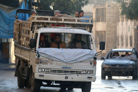 Men ride damaged vehicles with no windshields in a rebel-held besieged area in Aleppo, Syria December 2, 2016. REUTERS/Abdalrhman Ismail