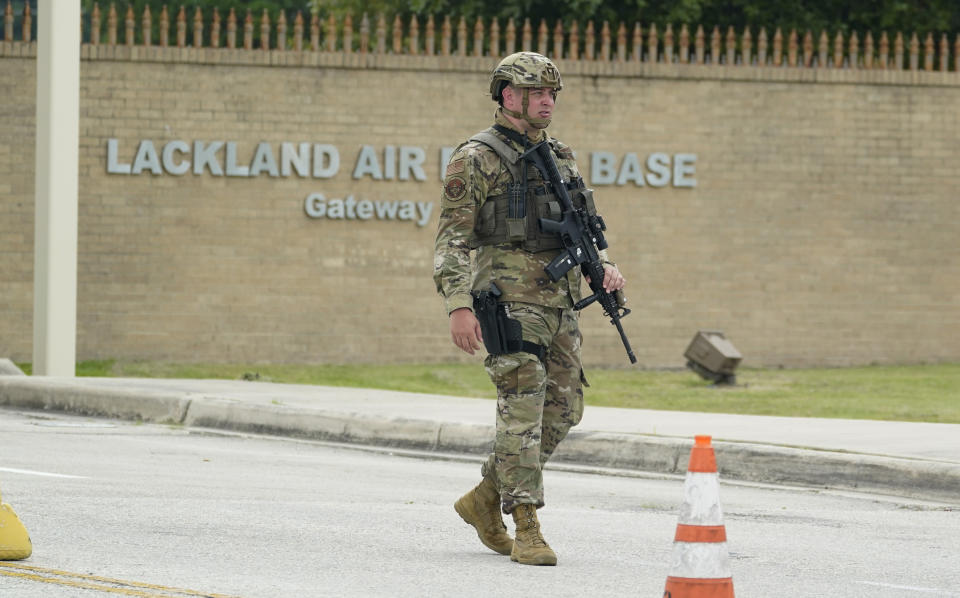 A military policeman stands guard at JBSA-Lackland Air Force Base game, Wednesday, June 9, 2021, in San Antonio. The Air Force was put on lockdown as police and military officials say they searched for two people suspected of shooting into the base from outside. (AP Photo/Eric Gay)