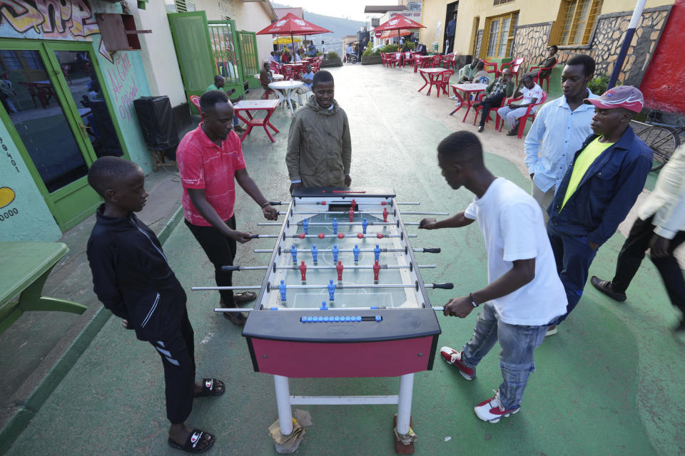 Rwandan youth play table football outdoors in in the streets of Kigali, Rwanda, Tuesday, April 4, 2024. The country will commemorate on April 7, 2024 the 30th anniversary of the genocide when ethnic Hutu extremists killed neighbours, friends and family during a three-month rampage of violence aimed at ethnic Tutsis and some moderate Hutus, leaving a death toll that Rwanda puts at 1,000,050. (AP Photo/Brian Inganga)
