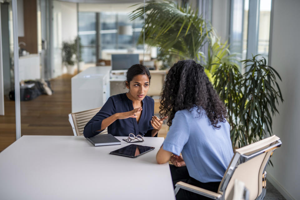 two female coworkers talking