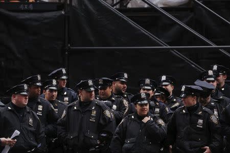 New York Police Department officers take part in a roll call as they wait for the beginning of New Year's Eve festivities in the Times Square area of New York December 31, 2015. REUTERS/Lucas Jackson