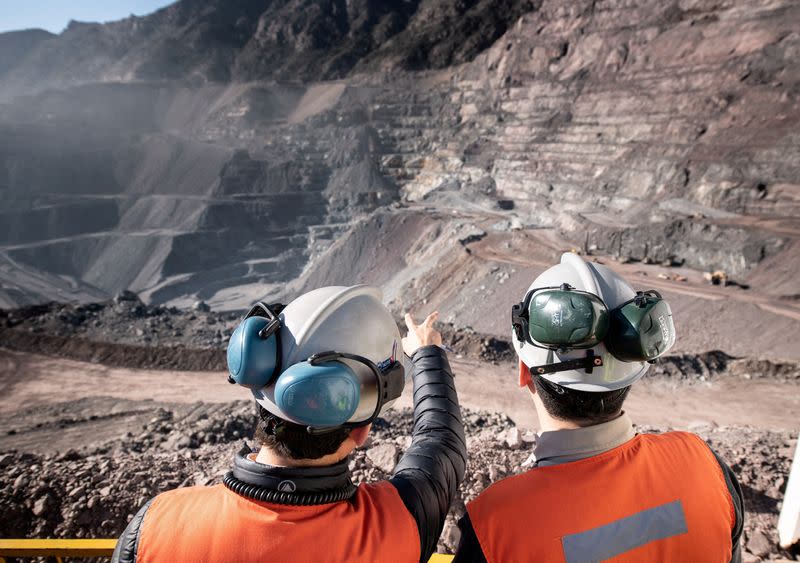 FILE PHOTO: Two men stand at Anglo American's El Soldado copper mine in Chile