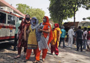 Relatives of a person who died of COVID- 19 leave after cremation in New Delhi, India, Monday, April 19, 2021. India's health system is collapsing under the worst surge in coronavirus infections that it has seen so far. Medical oxygen is scarce. Intensive care units are full. Nearly all ventilators are in use, and the dead are piling up at crematoriums and graveyards. Such tragedies are familiar from surges in other parts of the world — but were largely unknown in India. (AP Photo/Manish Swarup)