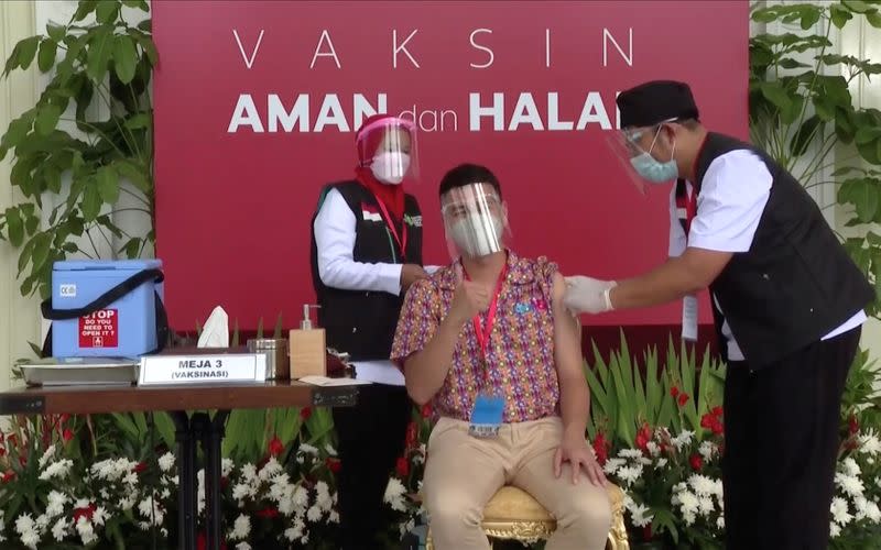 Indonesian influencer Raffi Ahmad receives a shot of the coronavirus disease (COVID-19) vaccine at the Merdeka Palace in Jakarta