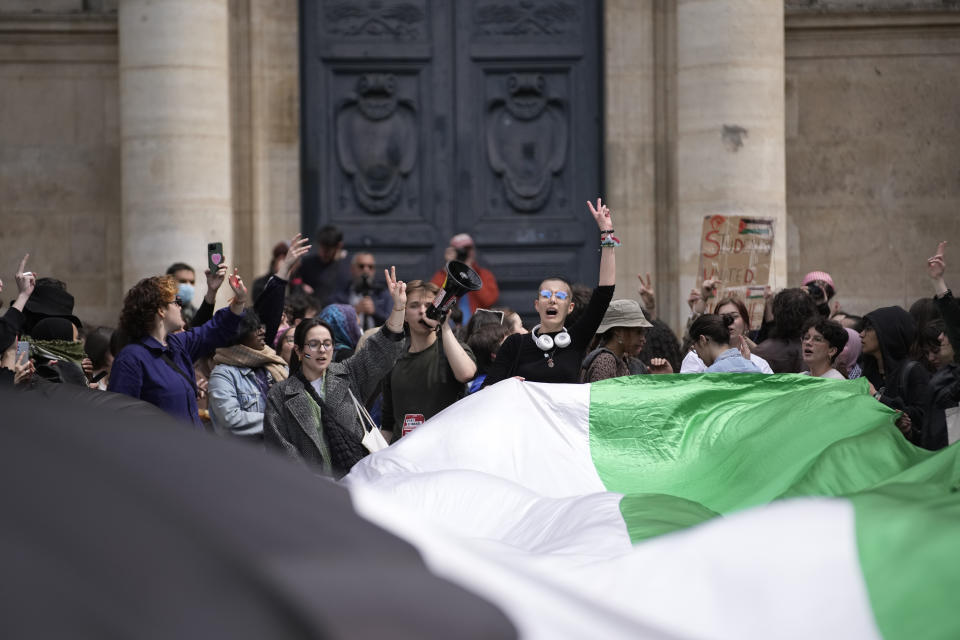 Students demonstrate outside La Sorbonne university with a huge Palestinian flag, Monday, April 29, 2024 in Paris. About 100 Pro-Palestinian students demonstrate near the Sorbonne university in Paris. The demonstration came on the heels of protests last week at another Paris-region school, Sciences Po. (AP Photo/Christophe Ena)