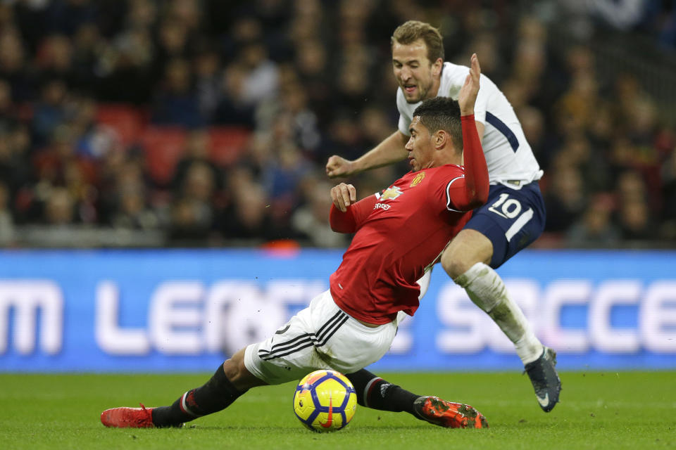 Manchester United’s Chris Smalling, front, and Tottenham’s Harry Kane vie for the ball