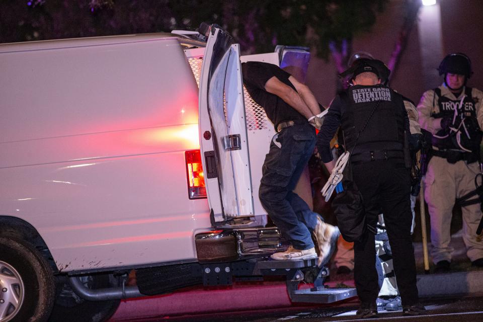 Arizona State troopers arrested some dozen protesters after they tore down fences around the perimeter of the Arizona Capitol at the end of an abortion-rights demonstration in Phoenix on June 25, 2022.