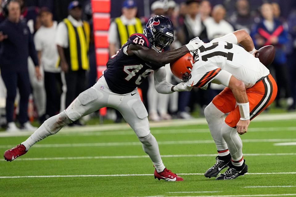 Houston Texans linebacker Christian Harris sacks Cleveland Browns quarterback Joe Flacco during the second half Saturday in Houston.