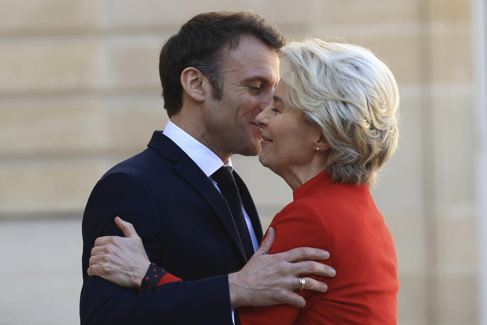 with French President Emmanuel Macron hugs European Commission president Ursula van der Leyen as she arrives for a working lunch, Monday, April 3, 2023 at the Elysee Palace in Paris. The two leaders will travel to China later this week. (AP Photo/Aurelien Morissard)