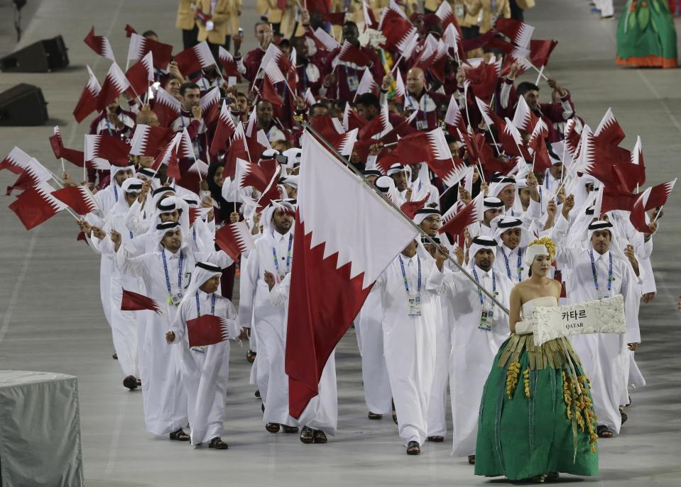 FILE - Athletes from Qatar march into the stadium during the opening ceremony for the 17th Asian Games in Incheon, South Korea,Friday, Sept. 19, 2014. Qatar will host the 2022 FIFA World Cup but soccer isn't the only sport played in the Gulf Arab country. From traditional pursuits to worldwide competitions, Qatar increasingly has marketed itself as a host for sports of all sorts. (AP Photo/Dita Alangkara, File)