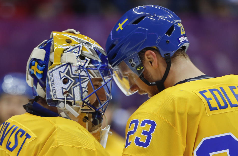 Sweden defenseman Alexander Edler congratulates goaltender Henrik Lundqvist on a shutout against Slovenia at the end of a men's quarterfinal ice hockey game at the 2014 Winter Olympics, Wednesday, Feb. 19, 2014, in Sochi, Russia. (AP Photo/Julio Cortez)