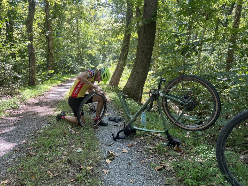 Marcus Romboy fixes a flat tire on his bike on the C&O Canal trail near Hancock, Maryland. | Dennis Romboy, Deseret News