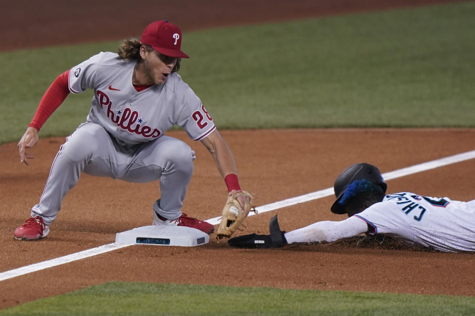 Philadelphia Phillies third baseman Alec Bohm tags out Miami Marlins' Jazz Chisholm Jr. as he is caught stealing third base during the first inning of a baseball game, Tuesday, May 25, 2021, in Miami. (AP Photo/Wilfredo Lee)