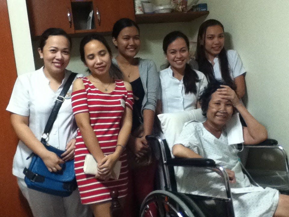 A group of Filipino nurses visit Arvin Temkar's mother, Daisy Perez, seated, in Mandaue City, Philippines, in November 2013.