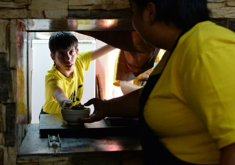 Employees work in the kitchen of the Training Cafe in Almaty on August 3, 2016