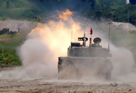 A Japan Ground Self Defense Force's Type 90 tank fires during their joint exercise, named Northern Viper 17, with U.S. Marine Corps at Hokudaien exercise area in Eniwa, on the northern island of Hokkaido, Japan, August 16, 2017.   REUTERS/Toru Hanai