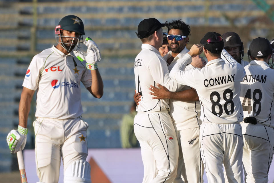 New Zealand's Ish Sodhi, center with glasses, celebrates with teammates after taking the wicket of Pakistan's Shan Masood, left, during the fourth day of first test cricket match between Pakistan and New Zealand, in Karachi, Pakistan, Thursday, Dec. 29, 2022. (AP Photo/Fareed Khan)