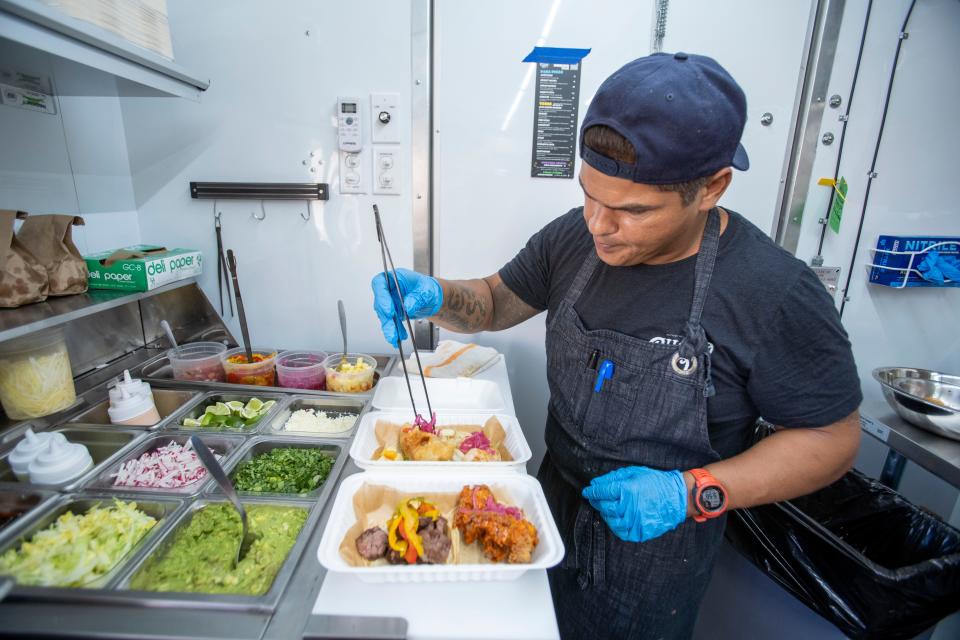 James Del Carpio puts together an order at the new mobile Cholo Soy Cocina food trailer set-up outside of Civil Society Brewing on a recent Thursday night.