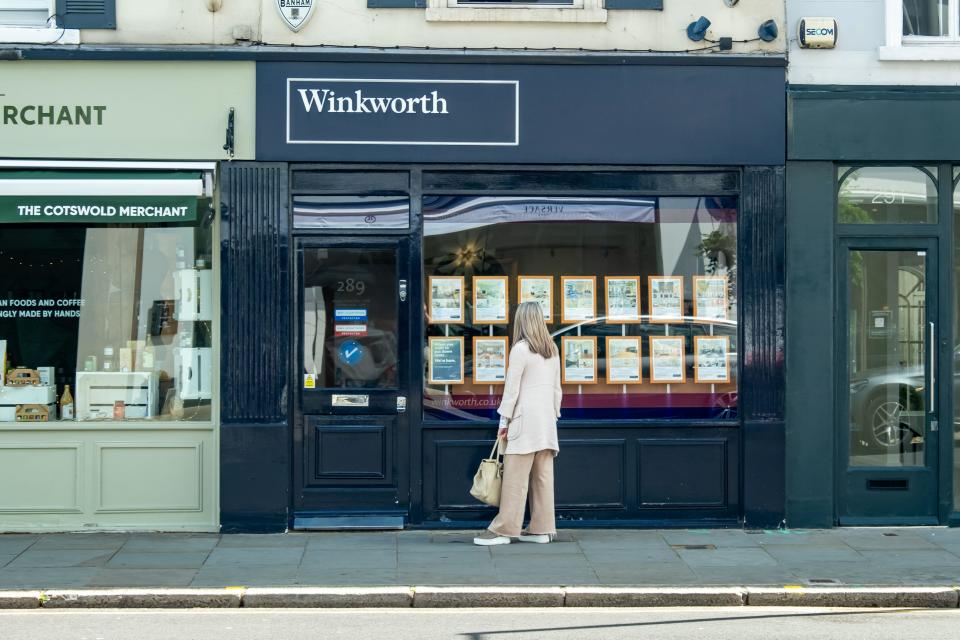 Mortgage rates: Person looking at properties being advertised in estate agent shop window