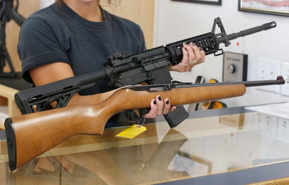 SPRINGVILLE, UT - JUNE 17: Courtney Manwaring holds an AR-15 (T) and a Ruger 10-22 (B) at Action Target on June 17, 2016 in Springville, Utah. (Photo by George Frey/Getty Images)