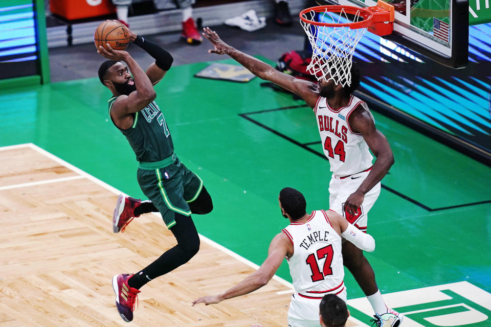 Boston Celtics guard Jaylen Brown (7) takes a shot against Chicago Bulls forward Patrick Williams (44) and forward Garrett Temple (17) during the first half of an NBA basketball game, Monday, April 19, 2021, in Boston. (AP Photo/Charles Krupa)