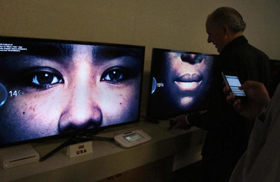 In this photo taken Wednesday, July 10, 2013, invited guests view the debut of the new series "Orange is the new black" at Netflix headquarters in Los Gatos, Calif. (AP Photo/Michael Liedtke)