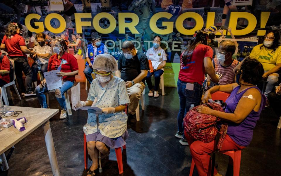 Elderly Filipinos are observed after being administered with the AstraZeneca COVID-19 vaccine at a sports arena -  Ezra Acayan/Getty Images