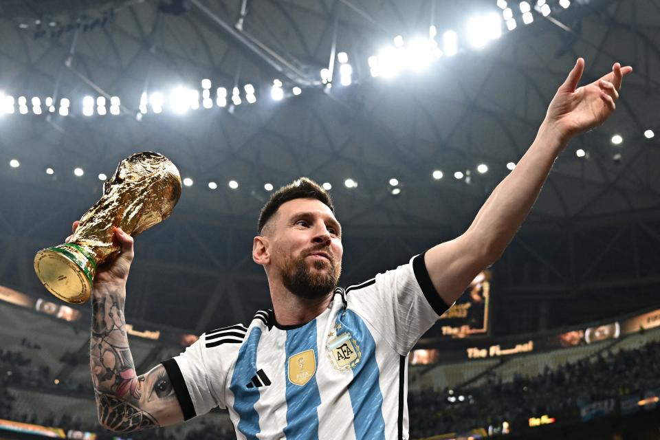 Argentina's captain and forward #10 Lionel Messi lifts the FIFA World Cup Trophy after Argentina won the Qatar 2022 World Cup final football match between Argentina and France at Lusail Stadium in Lusail, north of Doha on December 18, 2022.