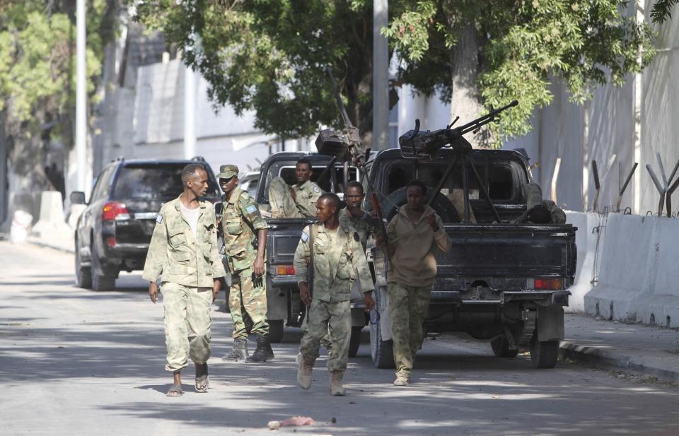 Somali security agents are seen outside the Central Hotel after a suicide attack in Somalia's capital Mogadishu February 20, 2015. Islamist rebels detonated a car bomb at the entrance of the hotel in the Somali capital on Friday and then stormed inside where politicians had gathered, killing at least 10 people including a lawmaker and lightly wounding two ministers. (REUTERS/Feisal Omar)